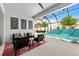 Covered patio with an outdoor living area and pool with water feature at 8720 Drummer Plank Dr, Wesley Chapel, FL 33545