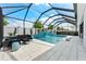 Screened in patio with a waterfall pool, in-pool loungers, and outdoor seating at 8720 Drummer Plank Dr, Wesley Chapel, FL 33545