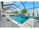 The pool features a unique waterfall feature, in-pool loungers, and a screened enclosure, offering privacy and shade at 8720 Drummer Plank Dr, Wesley Chapel, FL 33545