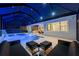 Wonderful screened pool area with a waterfall feature, sun shelves, outdoor kitchen, and patio seating at 8720 Drummer Plank Dr, Wesley Chapel, FL 33545