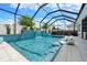 Backyard pool with a waterfall and covered patio area at 8720 Drummer Plank Dr, Wesley Chapel, FL 33545