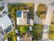 Aerial view of a beautiful property with a sparkling pool, lush landscaping, and a well-maintained lawn at 8801 Sunlit Cove Ne Dr, St Petersburg, FL 33702