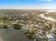 Stunning aerial view of neighborhood homes, lush greenery, and peaceful waterways at 8801 Sunlit Cove Ne Dr, St Petersburg, FL 33702