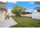 The backyard features a well-maintained lawn and mature trees creating a serene outdoor space at 8801 Sunlit Cove Ne Dr, St Petersburg, FL 33702