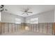 Unfinished basement featuring block wall and ceiling fan, ready for customization to suit your needs at 8801 Sunlit Cove Ne Dr, St Petersburg, FL 33702