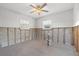 Unfinished basement featuring block wall and ceiling fan, ready for customization to suit your needs at 8801 Sunlit Cove Ne Dr, St Petersburg, FL 33702