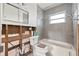 Remodeled bathroom featuring a sleek gray tile shower and new fixtures at 8801 Sunlit Cove Ne Dr, St Petersburg, FL 33702