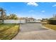 Exterior showcasing the home's front yard, driveway, and charming facade at 8801 Sunlit Cove Ne Dr, St Petersburg, FL 33702