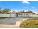 Charming single-story home featuring a well-maintained yard and attached garage at 8801 Sunlit Cove Ne Dr, St Petersburg, FL 33702