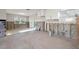 Open floor plan showing the kitchen with white cabinets, and bright lighting at 8801 Sunlit Cove Ne Dr, St Petersburg, FL 33702