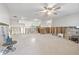 Expansive living room with a ceiling fan, offering a bright and airy space at 8801 Sunlit Cove Ne Dr, St Petersburg, FL 33702