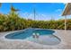 Sparkling pool surrounded by lush tropical landscaping and a beautiful patio area at 8801 Sunlit Cove Ne Dr, St Petersburg, FL 33702