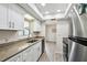 Efficient kitchen features white cabinetry, granite countertops, and stainless steel appliances at 8846 Hunter Dr, New Port Richey, FL 34653