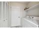 Laundry room featuring a washer, a dryer, and upper cabinet storage at 8846 Hunter Dr, New Port Richey, FL 34653