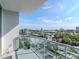 City view from a balcony, with modern glass railings overlooking street, trees, and skyline at 912 Channelside Dr # 2501, Tampa, FL 33602