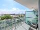 Relaxing balcony view with seating, showcasing the cityscape and ocean beyond the modern glass railing at 912 Channelside Dr # 2501, Tampa, FL 33602