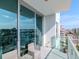 Balcony features comfortable seating and a view of the city, complemented by modern glass railings at 912 Channelside Dr # 2501, Tampa, FL 33602