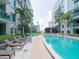 Enjoy relaxing by the in-ground pool with comfortable lounge chairs and tropical landscaping surrounding it at 912 Channelside Dr # 2501, Tampa, FL 33602