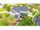 Aerial view of home with a large lot, black roof, palm trees and attached garage at 9607 Orange Jasmine Way, Tampa, FL 33647