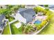 Private backyard features a custom pool with waterfall, gazebo, lush tropical landscaping and large back yard at 9607 Orange Jasmine Way, Tampa, FL 33647