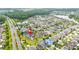 Aerial view of the home showcasing landscaping, and neighborhood amenities with the location marked by an arrow at 9607 Orange Jasmine Way, Tampa, FL 33647