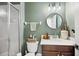 Bathroom featuring a glass-enclosed shower, vanity with sink, and modern finishes at 9607 Orange Jasmine Way, Tampa, FL 33647