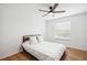 Bedroom featuring wood-look floors, a ceiling fan, and a comfortable bed at 9607 Orange Jasmine Way, Tampa, FL 33647