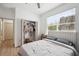 Bright bedroom featuring a large window, and open closet with modern finishes at 9607 Orange Jasmine Way, Tampa, FL 33647