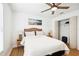 Bright bedroom with a ceiling fan, two side tables, and a closet for storage at 9607 Orange Jasmine Way, Tampa, FL 33647