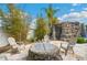An outdoor firepit surrounded by seating in a backyard oasis at 9607 Orange Jasmine Way, Tampa, FL 33647