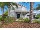 Charming two-story home with a welcoming front porch and well-manicured landscaping at 9607 Orange Jasmine Way, Tampa, FL 33647