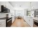 Bright kitchen featuring a modern design with stainless appliances and a seamless flow to the dining area at 9607 Orange Jasmine Way, Tampa, FL 33647