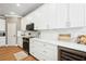 Contemporary kitchen features white cabinets, quartz counters, stainless steel appliances, and wine fridge at 9607 Orange Jasmine Way, Tampa, FL 33647