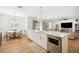 Bright kitchen with an island and open floor plan, seamlessly connecting to the dining and living areas at 9607 Orange Jasmine Way, Tampa, FL 33647