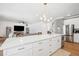 Modern kitchen with white cabinetry, quartz countertops, stainless steel appliances, and island seating at 9607 Orange Jasmine Way, Tampa, FL 33647