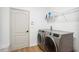 Clean laundry room with modern, stainless steel washer and dryer units at 9607 Orange Jasmine Way, Tampa, FL 33647