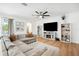 Comfortable living room featuring a large sectional sofa, fireplace, and stylish décor at 9607 Orange Jasmine Way, Tampa, FL 33647
