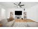 Inviting living room features a comfortable sofa, fireplace, and built-in bookshelves for a cozy atmosphere at 9607 Orange Jasmine Way, Tampa, FL 33647