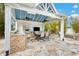 An outdoor kitchen with built in appliances and dining area at 9607 Orange Jasmine Way, Tampa, FL 33647
