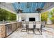 Outdoor kitchen and dining area with a blue ceiling at 9607 Orange Jasmine Way, Tampa, FL 33647