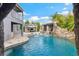 Stunning pool featuring a rock waterfall, water features, outdoor kitchen and stone patio at 9607 Orange Jasmine Way, Tampa, FL 33647