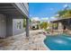Beautiful outdoor area with travertine deck, poolside cabana, outdoor kitchen and rock waterfall feature at 9607 Orange Jasmine Way, Tampa, FL 33647
