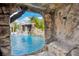 View of the pool and rock waterfall feature from the grotto structure in the backyard at 9607 Orange Jasmine Way, Tampa, FL 33647