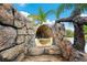Pool area featuring a custom rock waterslide with lush landscaping and a lagoon-style design at 9607 Orange Jasmine Way, Tampa, FL 33647