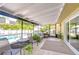 Relaxing screened patio with comfortable seating, plants, and a view of the sparkling pool area at 910 Black Knight Dr, Valrico, FL 33594