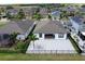 Aerial view of a fenced backyard with patio and view of lake in neighborhood at 10008 Celtic Ash Dr, Ruskin, FL 33573