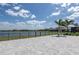 Expansive back patio with pavers, a hammock and picturesque view of the lake and neighborhood at 10008 Celtic Ash Dr, Ruskin, FL 33573