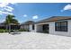 Well-maintained back patio with pavers, outdoor seating, and a lovely backyard view at 10008 Celtic Ash Dr, Ruskin, FL 33573