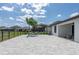 Wide back patio with pavers, a hammock, and outdoor dining area with a view of the neighborhood and lake at 10008 Celtic Ash Dr, Ruskin, FL 33573
