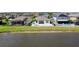 Spacious backyard with a patio, palm tree, and fence overlooking the tranquil lake at 10008 Celtic Ash Dr, Ruskin, FL 33573